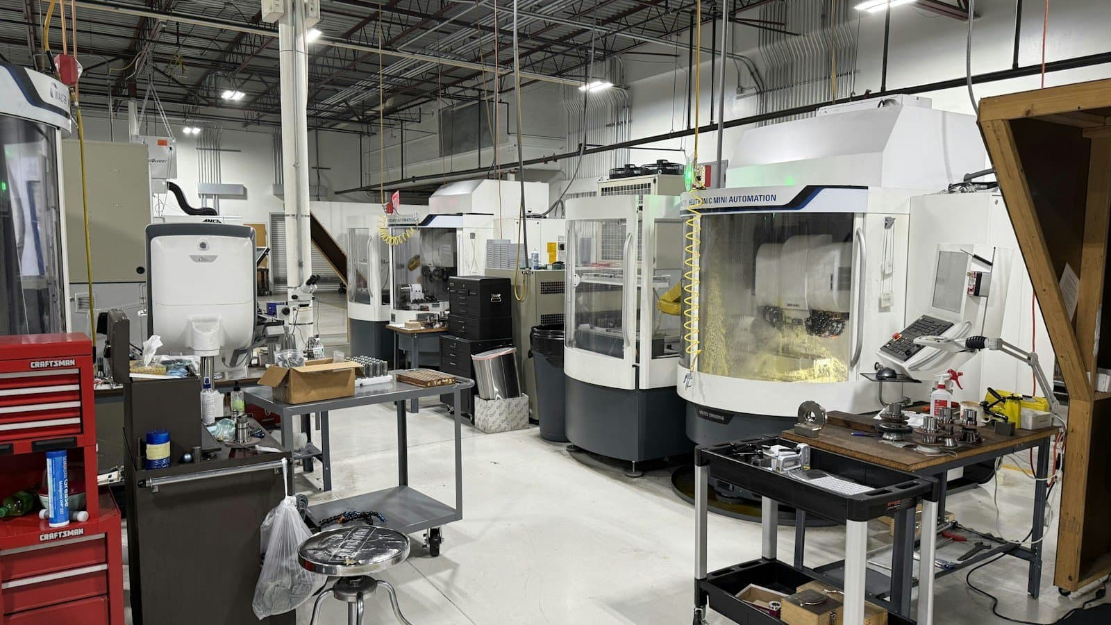 Modern industrial manufacturing workshop with CNC machines and metalworking tools
