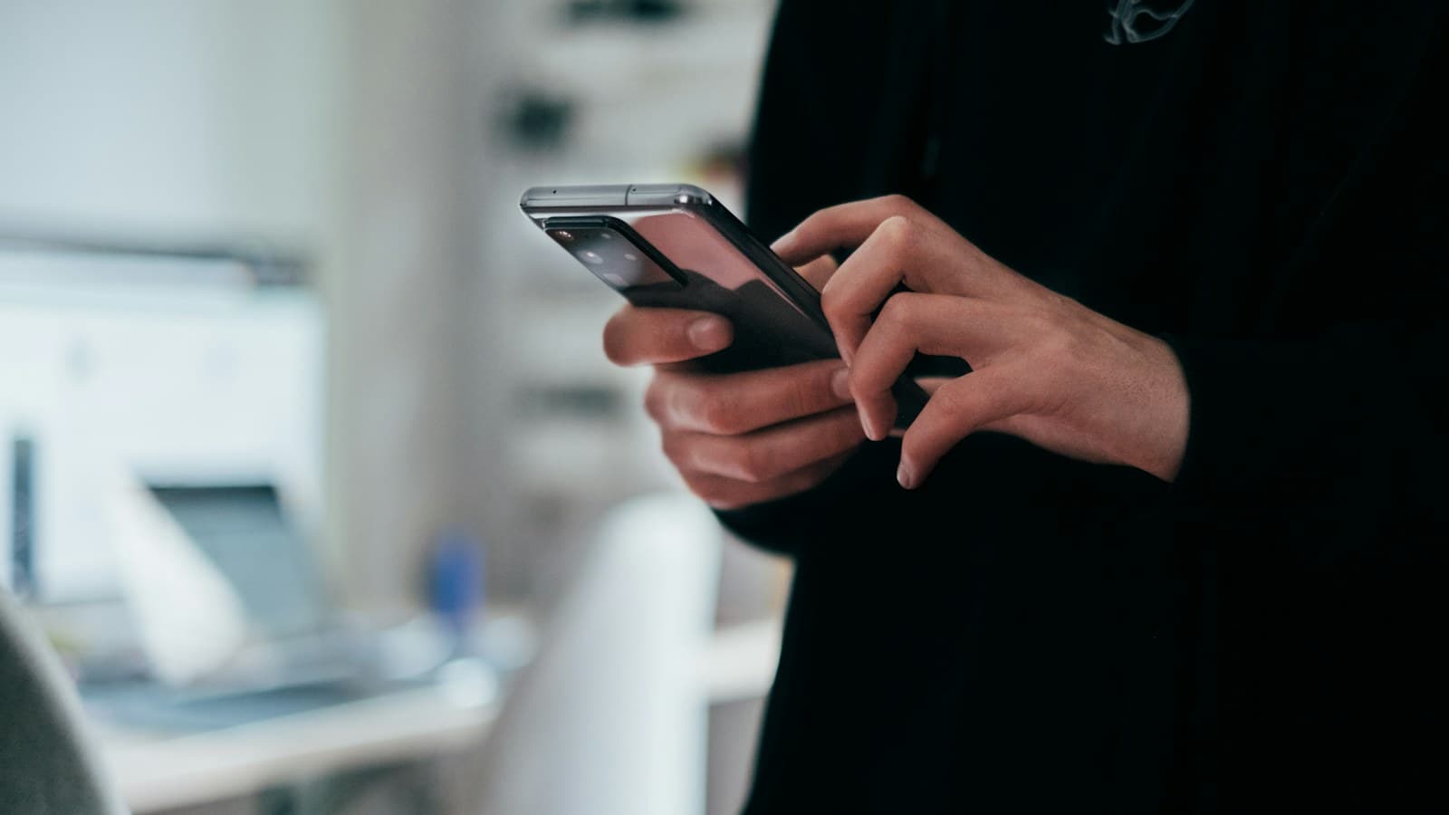 Person holding a smartphone to review daily habits, routine and progress