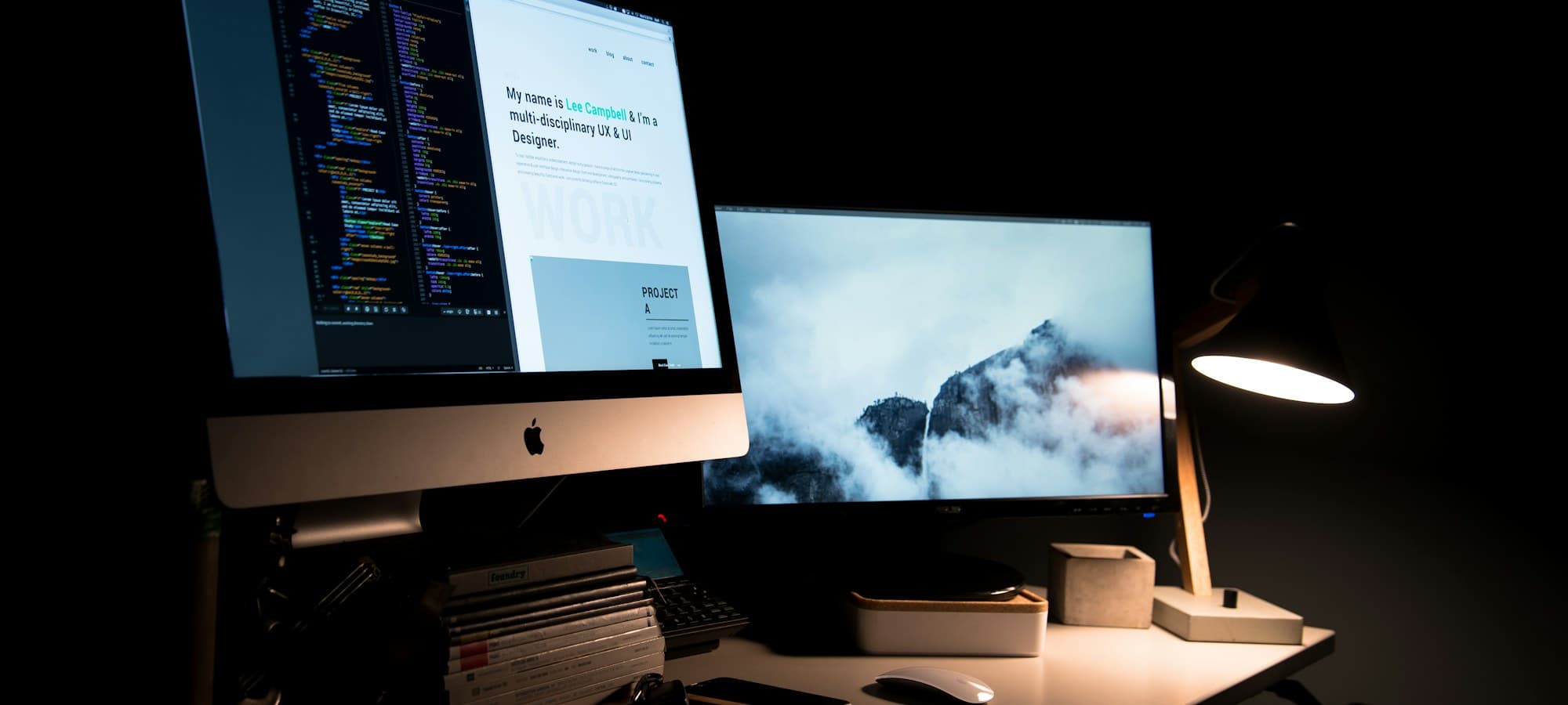 Laptop displaying website and app design screens in a digital design studio